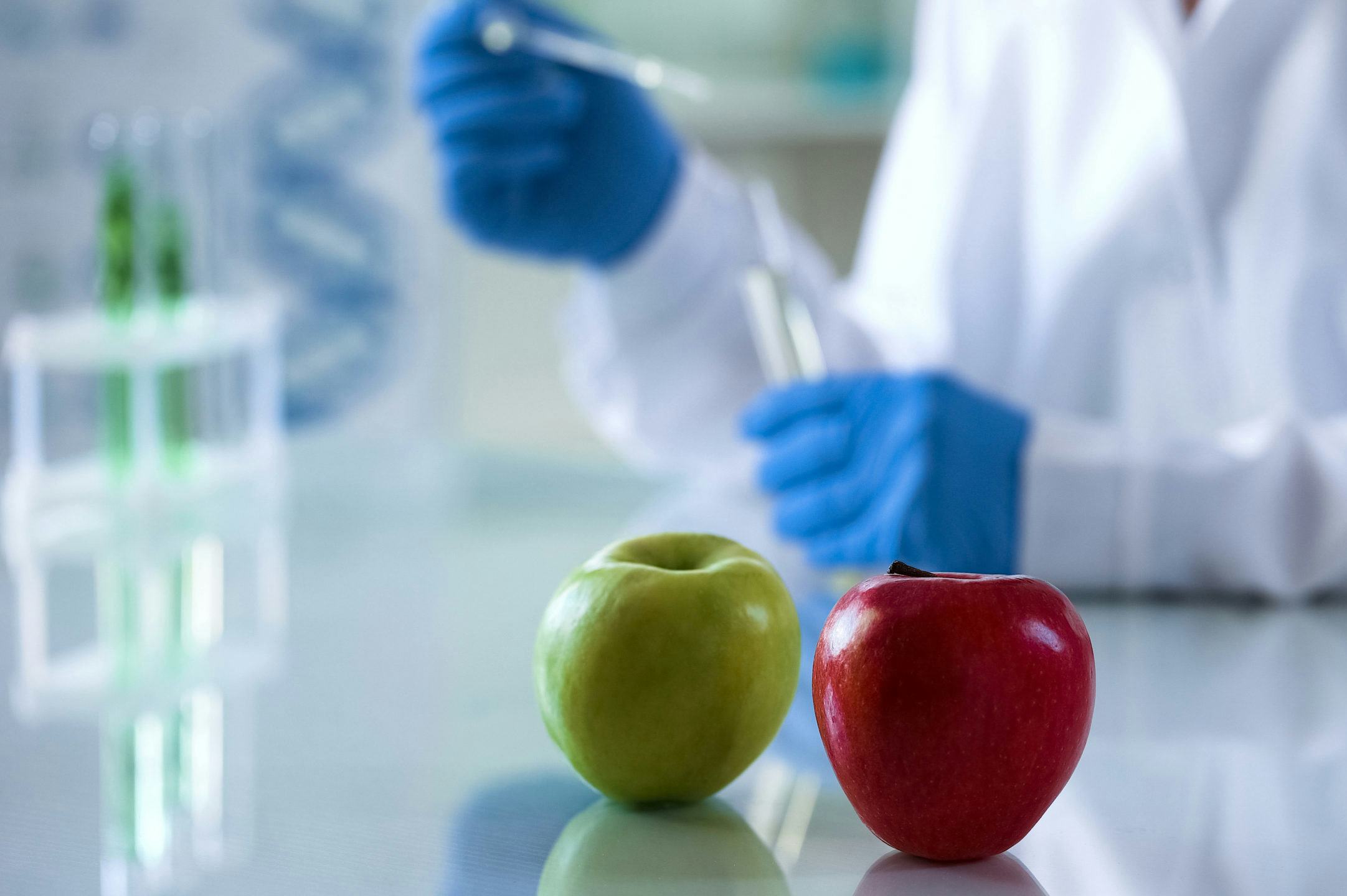Fruits lying on lab table, scientist checking food quality, nutritional studies